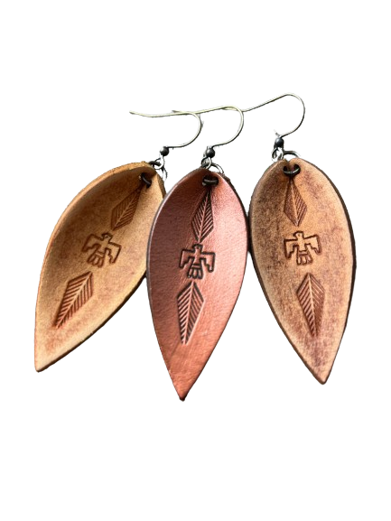 a pair of earrings with three different designs on them