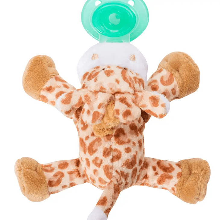 a stuffed giraffe with a pacifier in its mouth