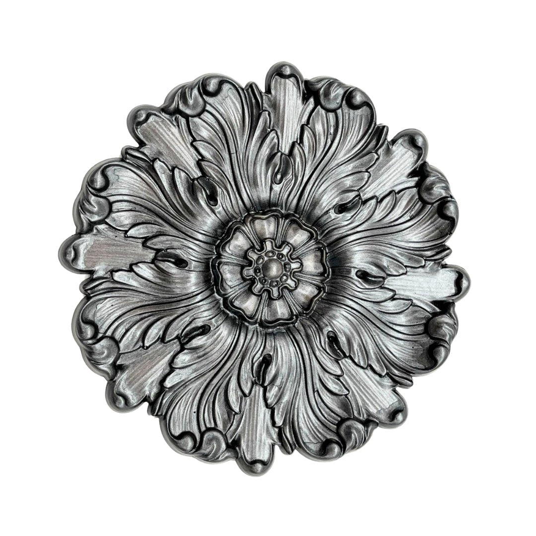 a metal plate with a flower design on it