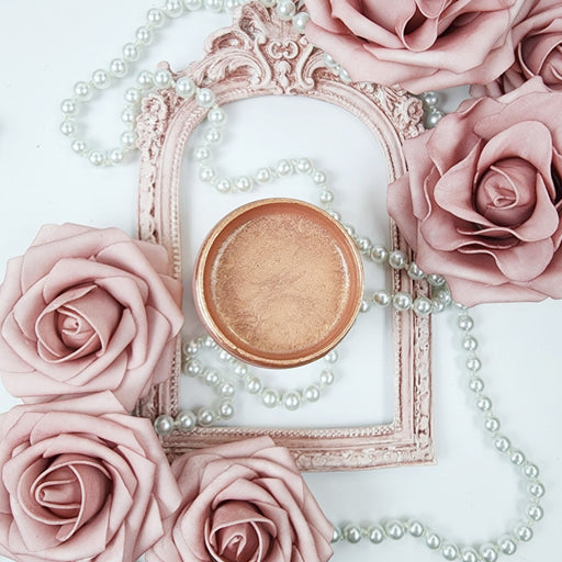 a close up of a powder in a bowl surrounded by flowers