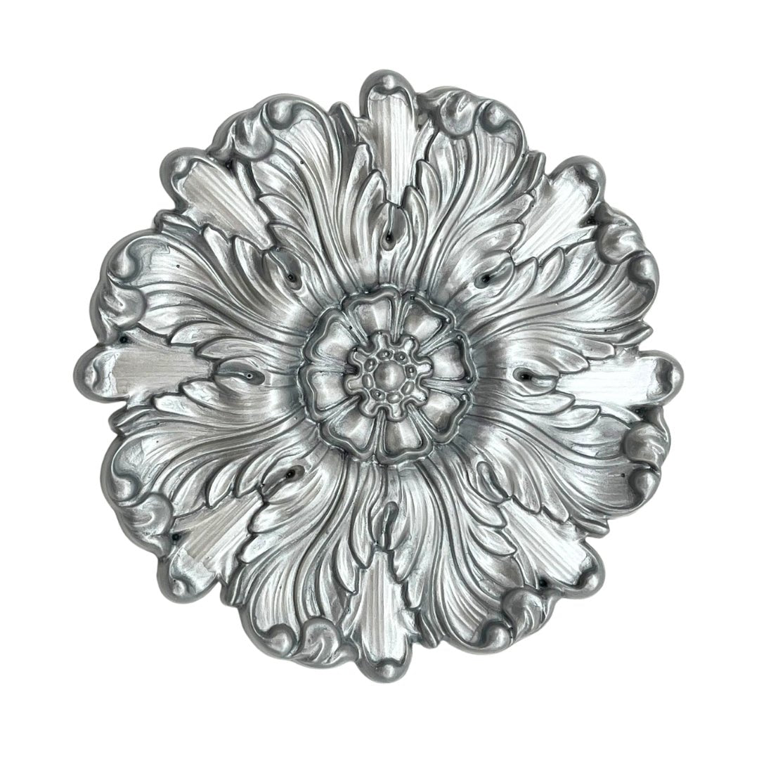 a drawing of a silver flower on a white background