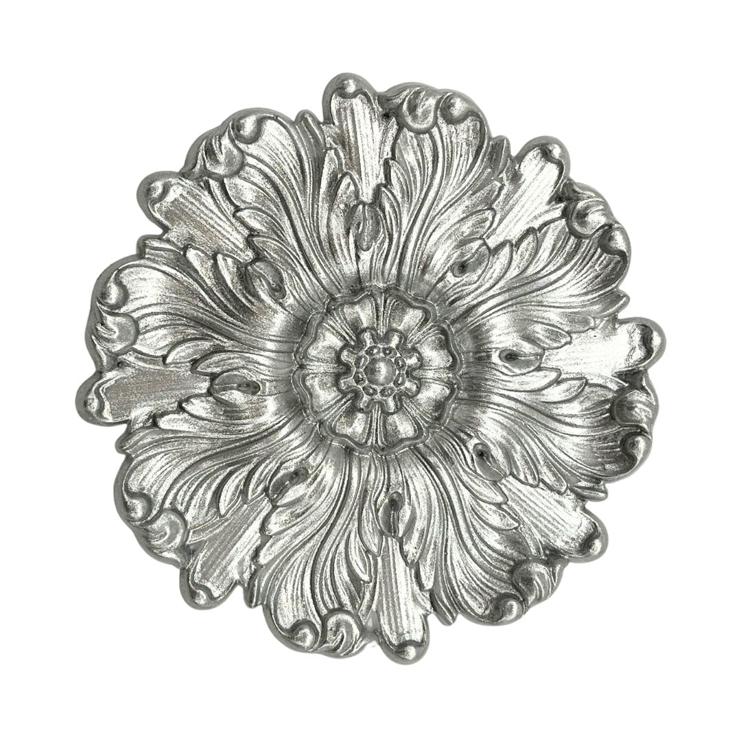 a metal object with a flower design on it