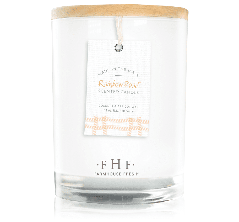 a candle with a tag hanging from it and a wood top