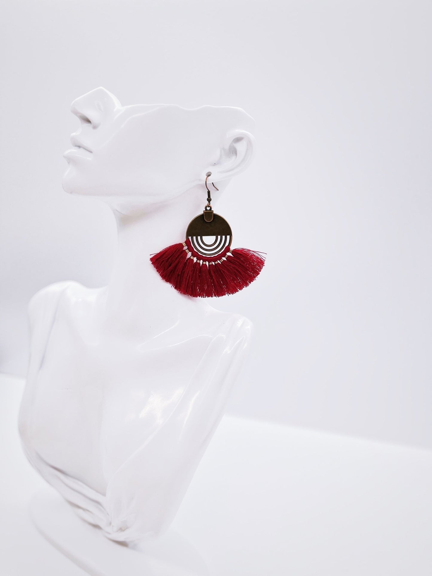 red fan earrings on mannequin bust