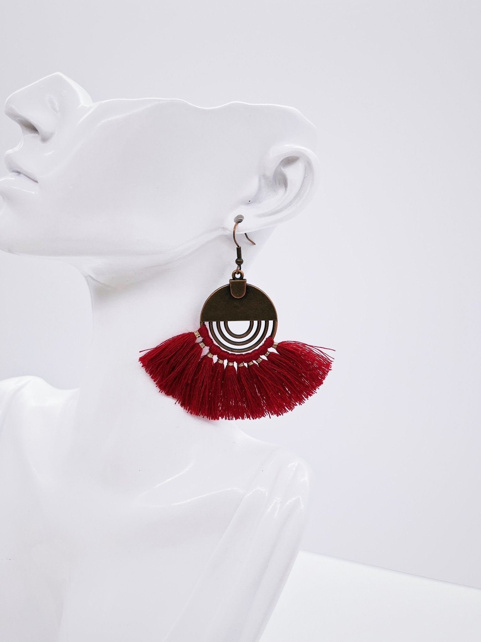 red fan earrings on mannequin bust