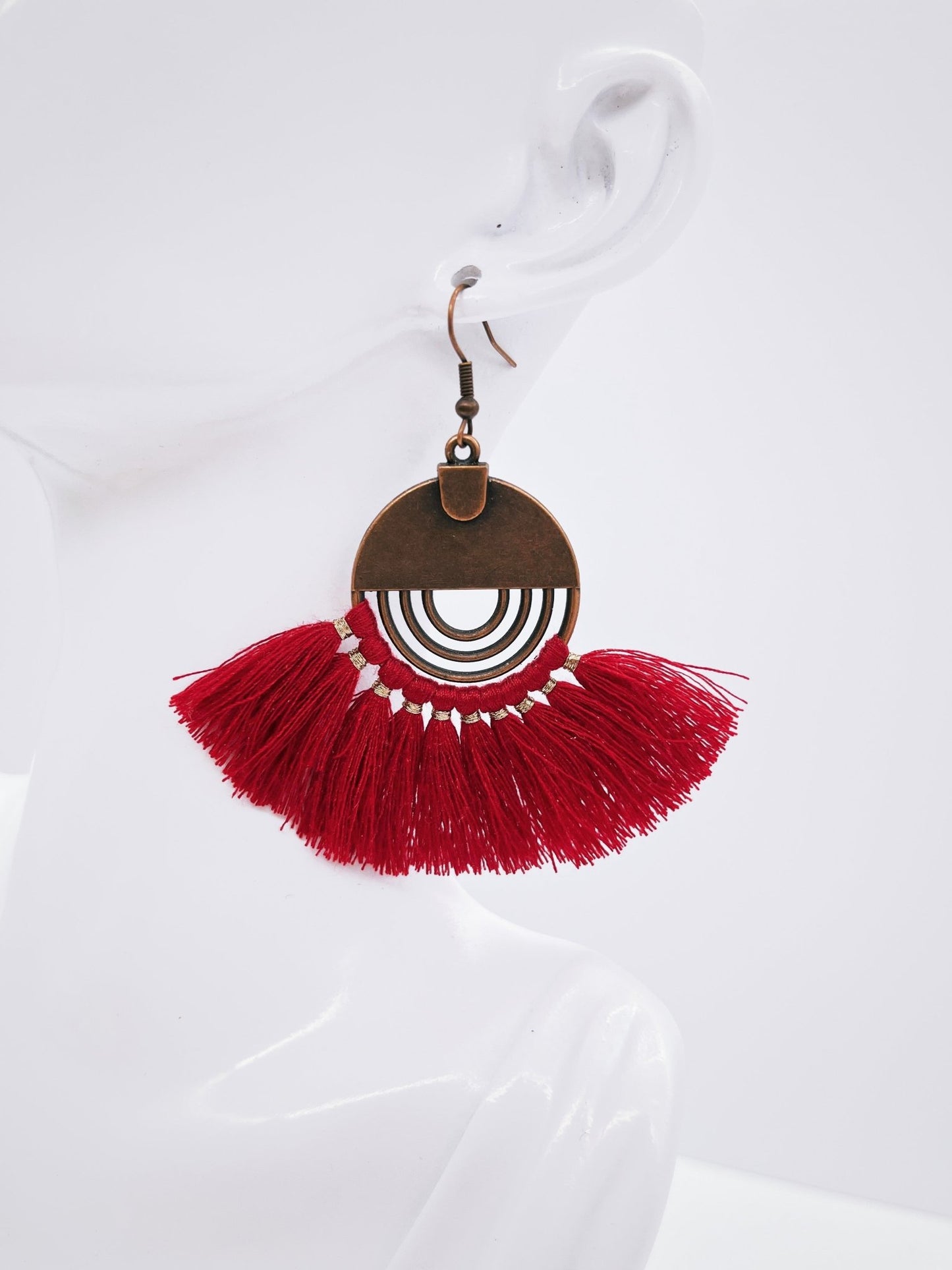 red fan earrings on mannequin bust