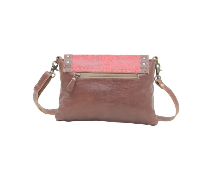 a brown and pink purse on a white background