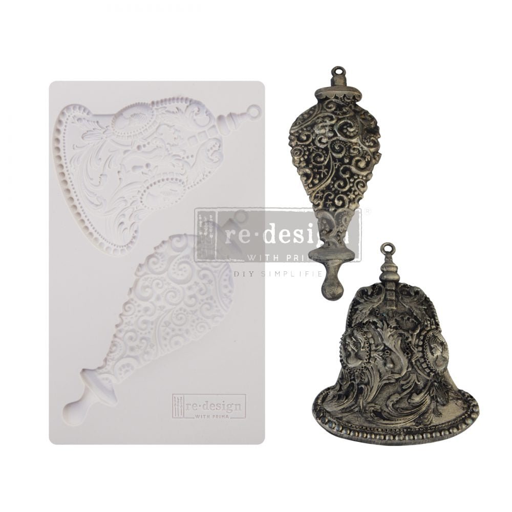 a metal bell and a card with a design on it