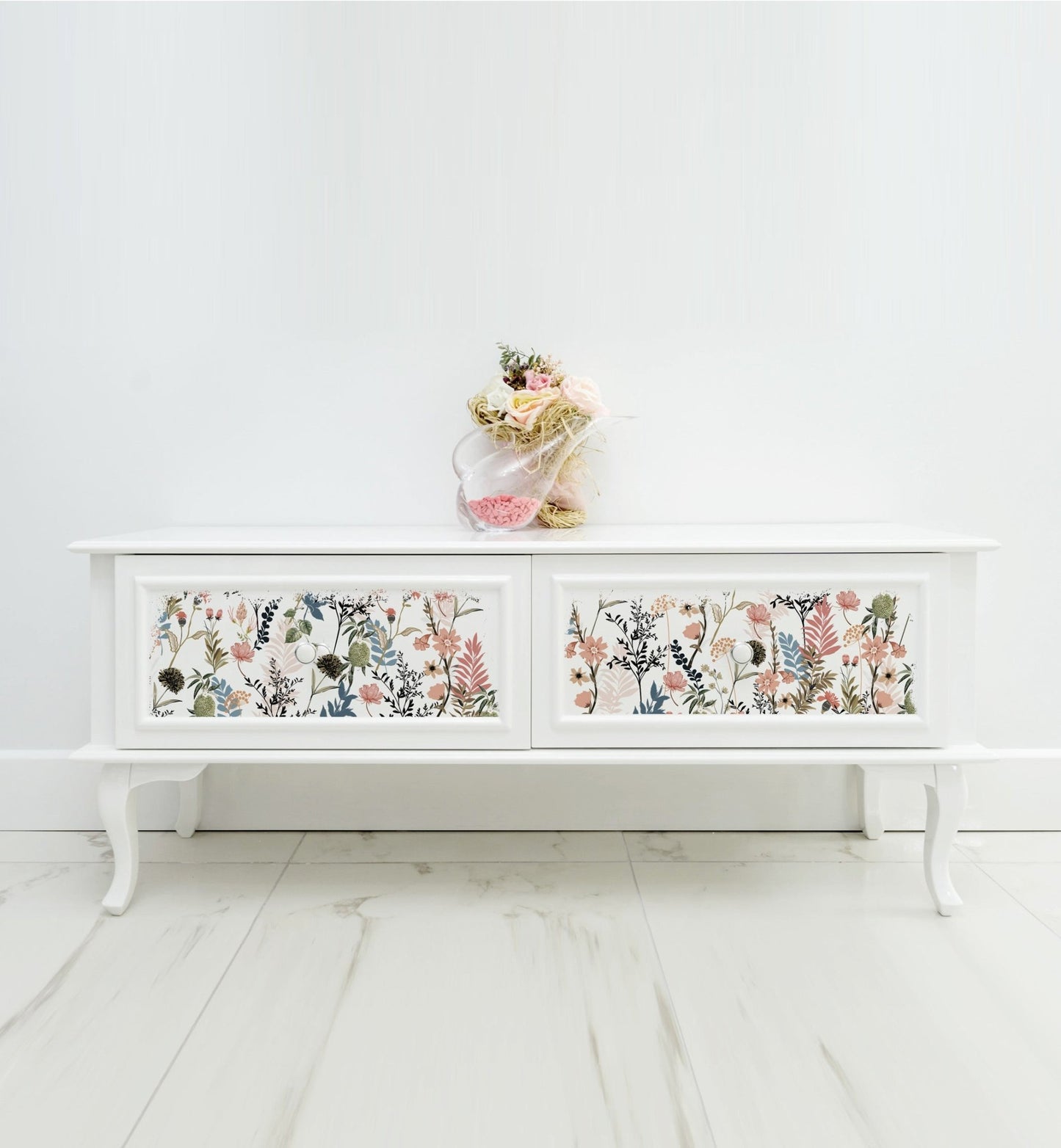 a white cabinet with flowers painted on it