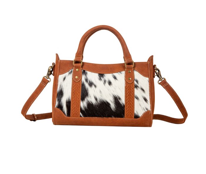 a handbag with a cow print pattern on it