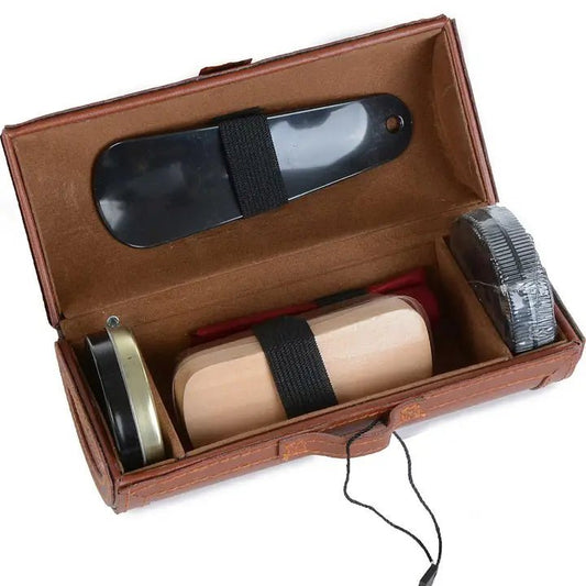 a shoe shine kit with shoehorn and brush and shoeshine pucks in it