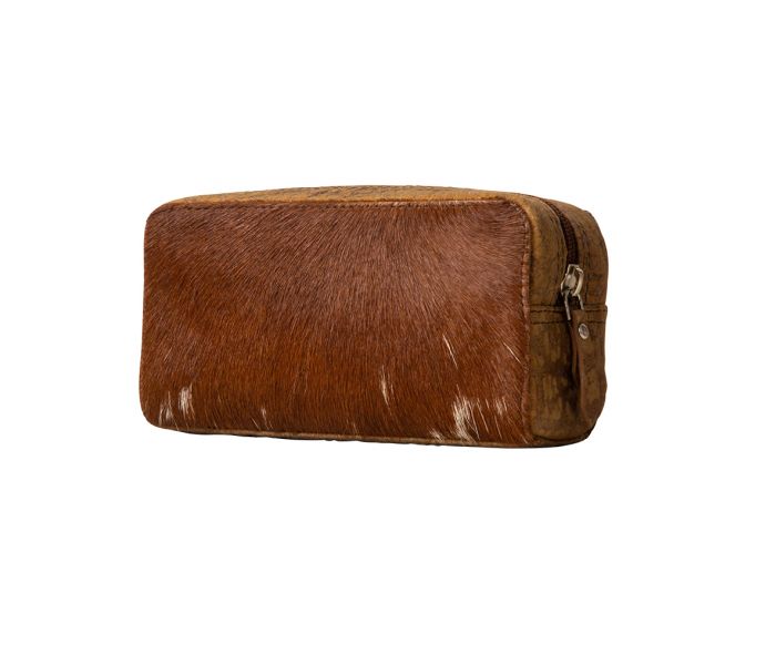 a brown and white cowhide bag on a white background