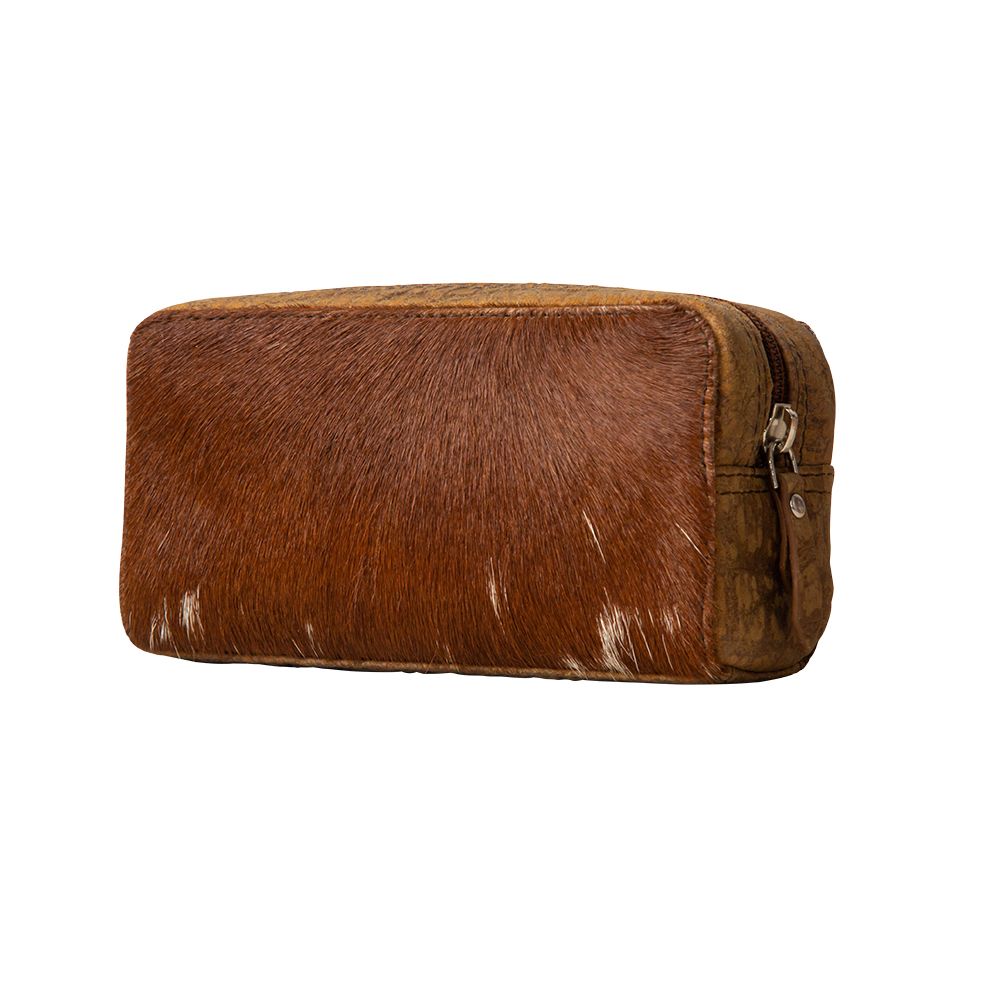 a brown and white cowhide bag on a white background