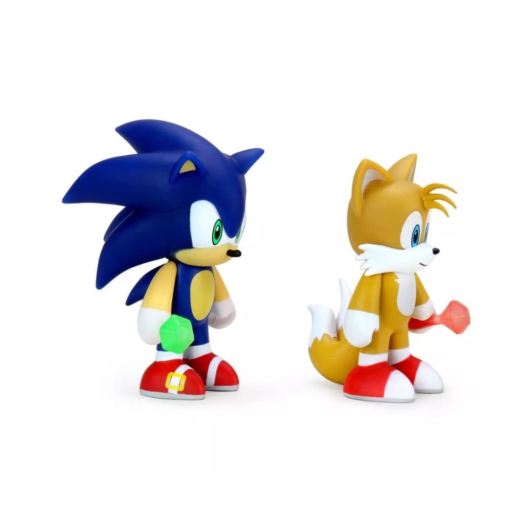 two figurines of sonic and tails on a white background