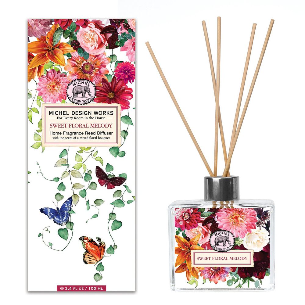 Michel Design Works Sweet Floral Melody reed diffuser showcasing a stylish glass decanter and colorful floral design with butterflies, perfect for adding a fragrant touch to any room.