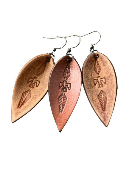 a pair of earrings with three different designs on them