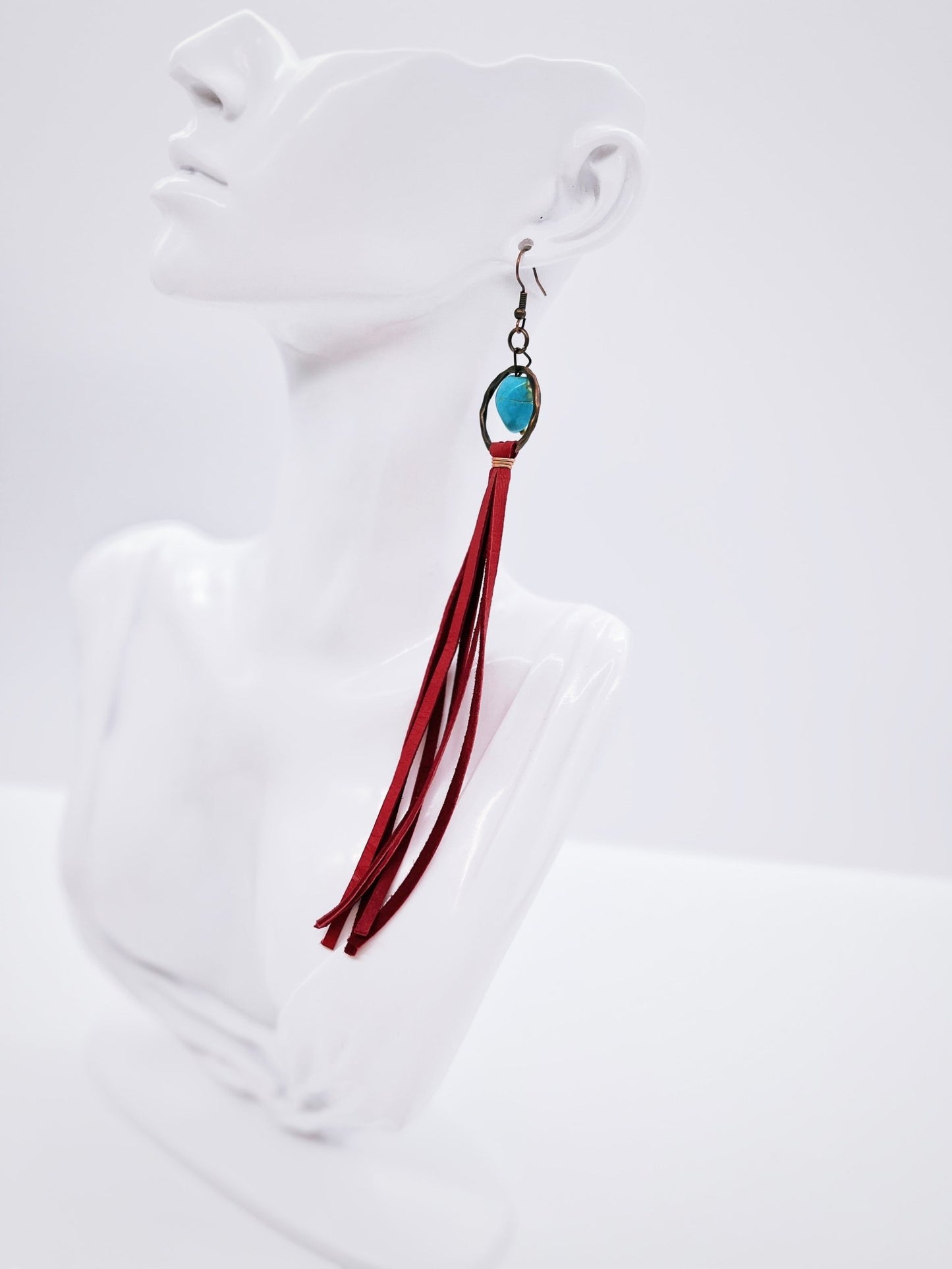 Turquoise Drop Earrings with Red Leather Tassel on mannequin display