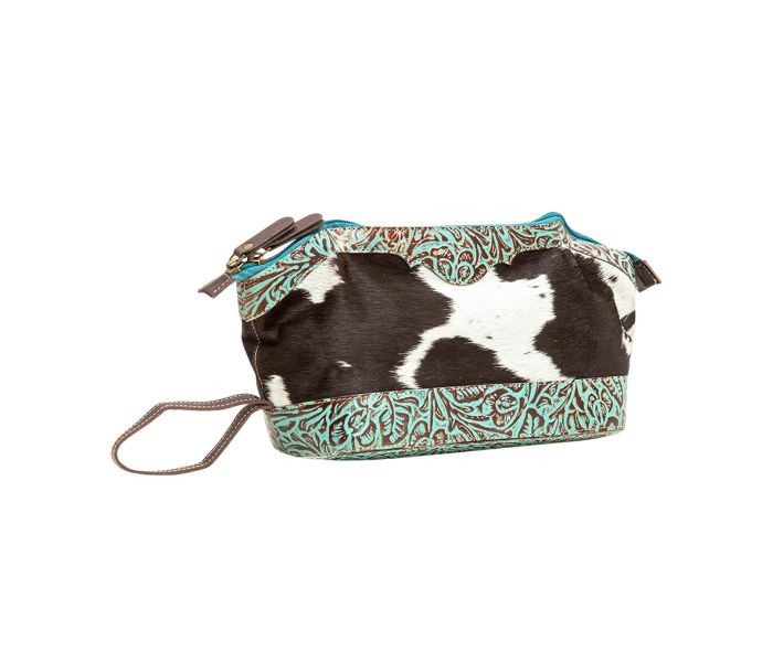 a cow print bag on a white background