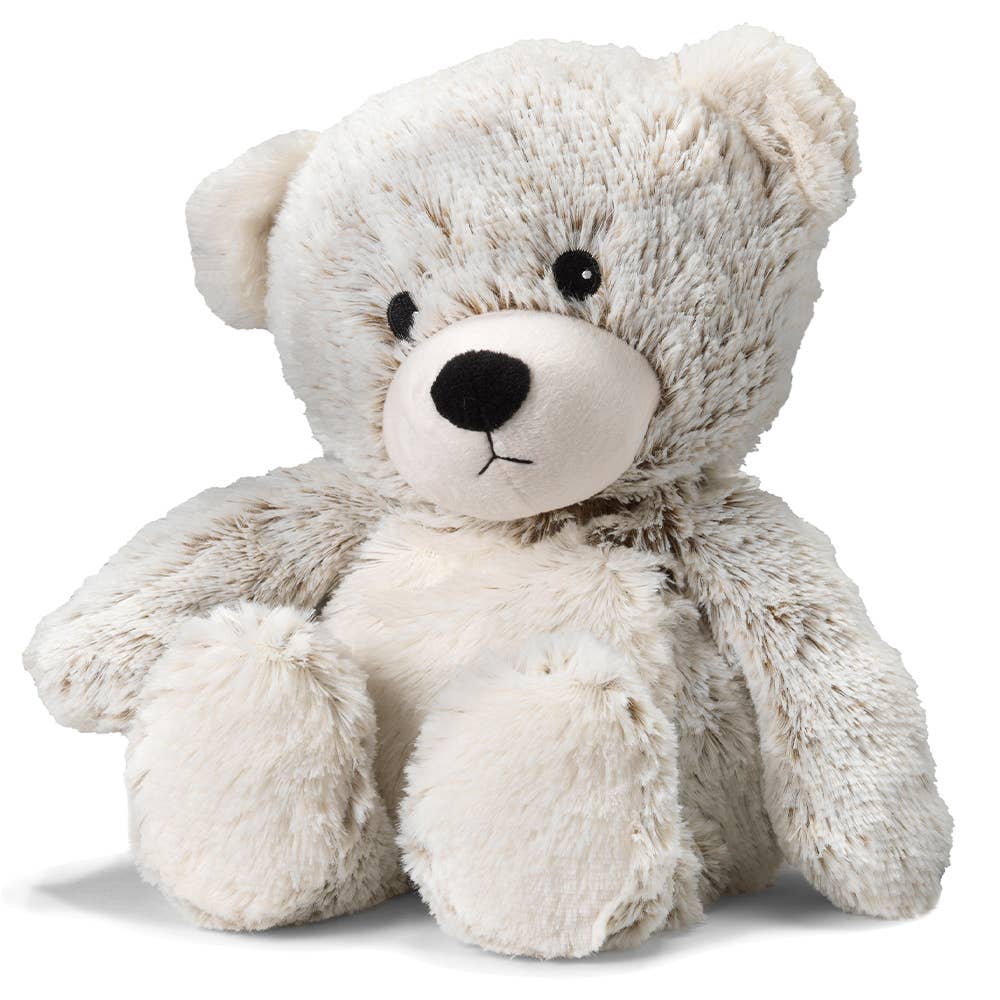 a white teddy bear with a black nose