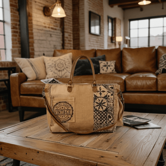 a vintage looking weekender bag with a patchwork design on it sitting on a coffee table in a living room