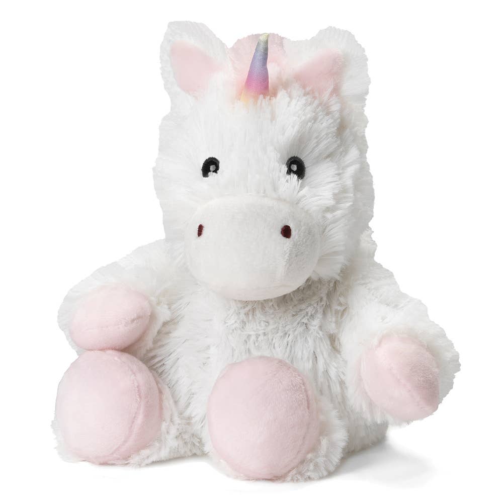 a white unicorn stuffed animal sitting on white background