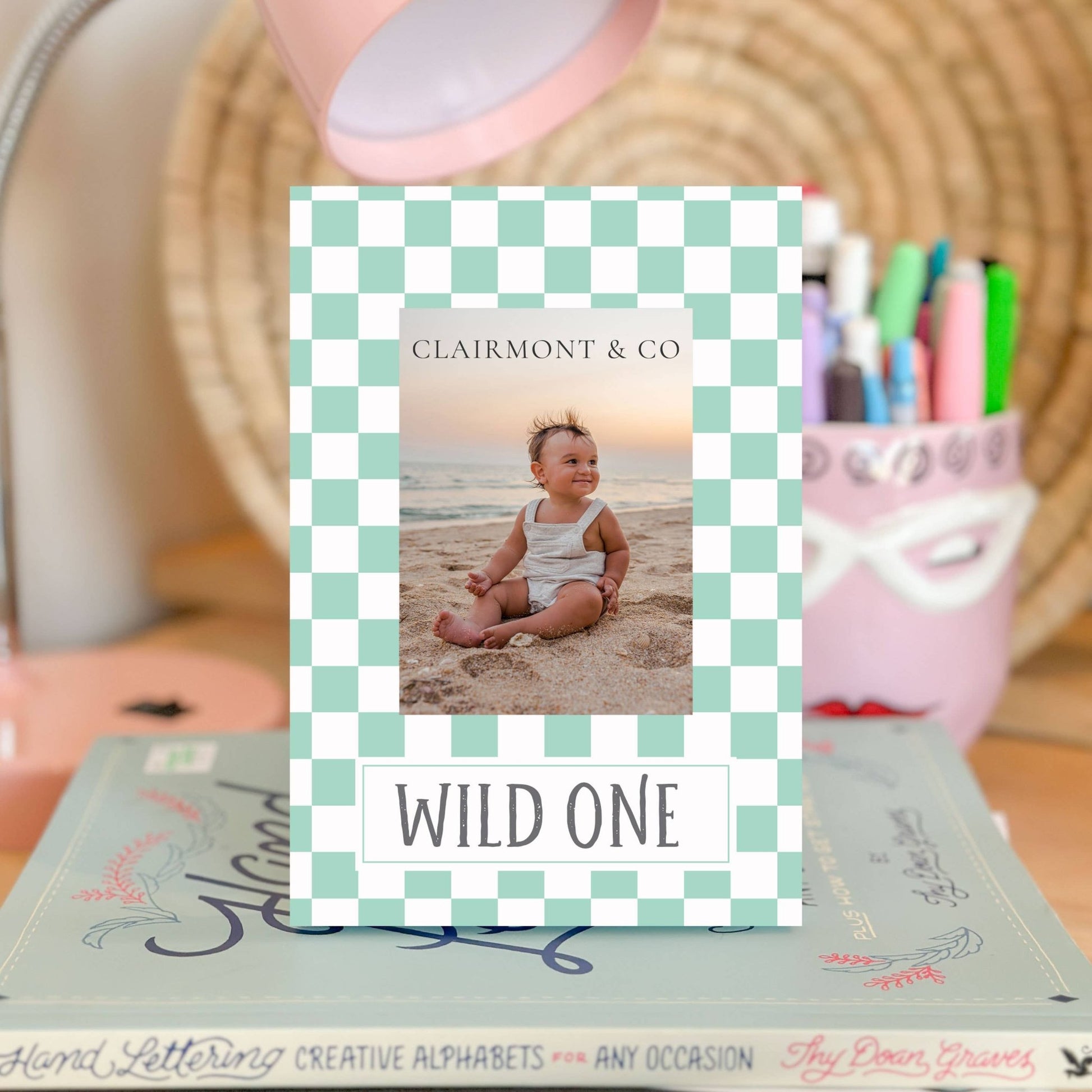 a frame with the words WILD ONE with a picture of a baby in it