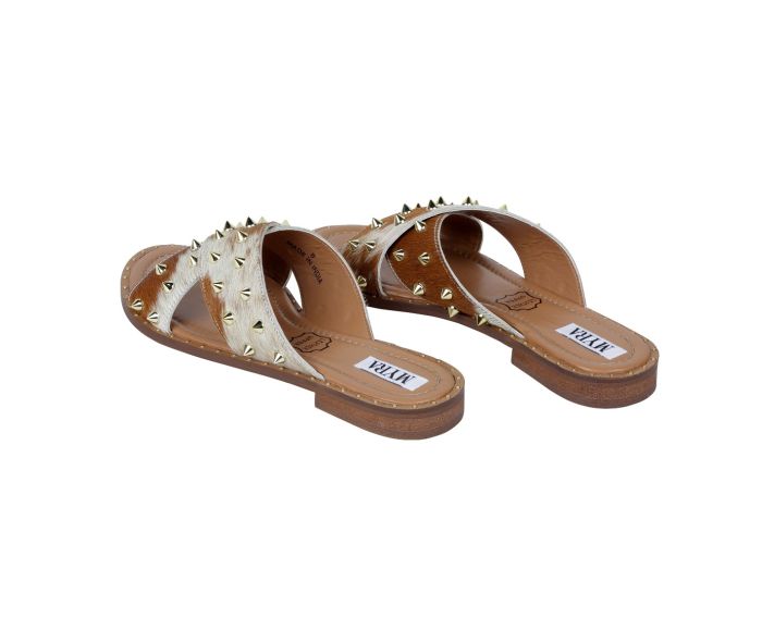 a pair of white sandals with studded straps