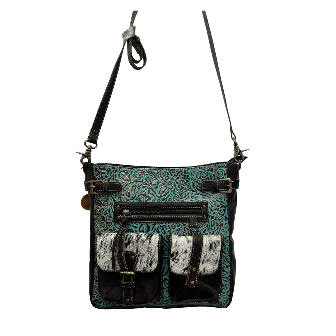 a handbag with a cow print design on it