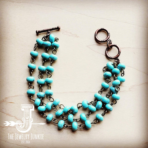 a necklace made of turquoise beads and metal links