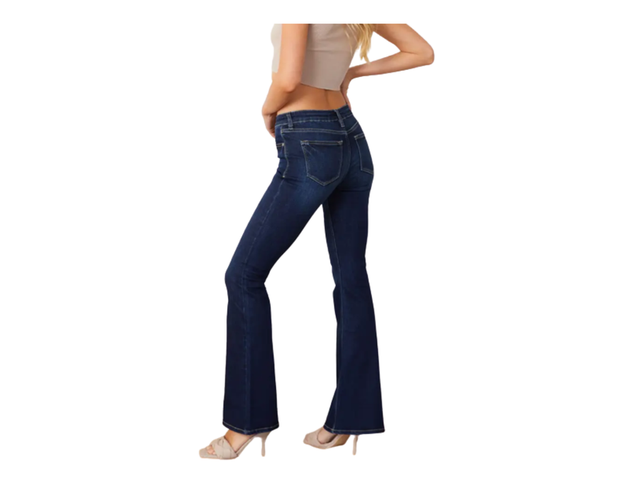 a woman in high rise jeans with her hands on her hips