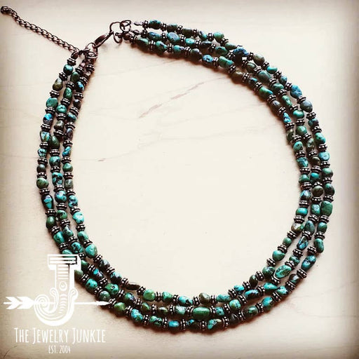 a long necklace with turquoise beads and a silver clasp