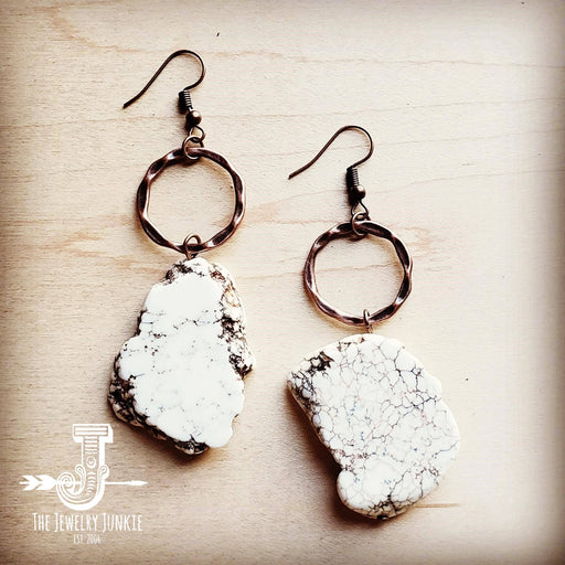 a pair of white and black stone earrings