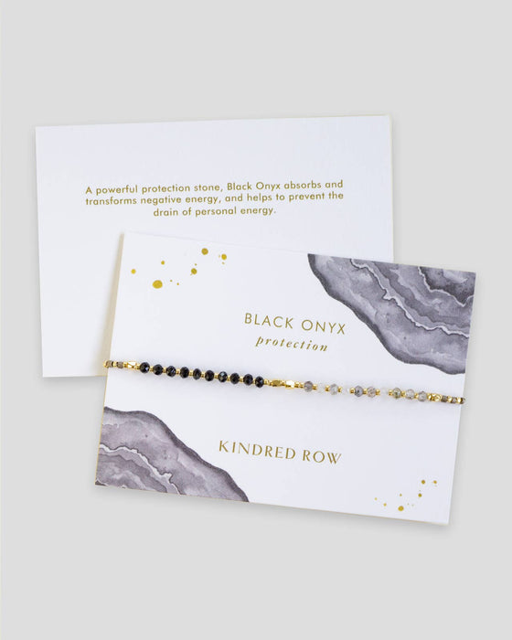 a black onyx beaded bracelet on a card