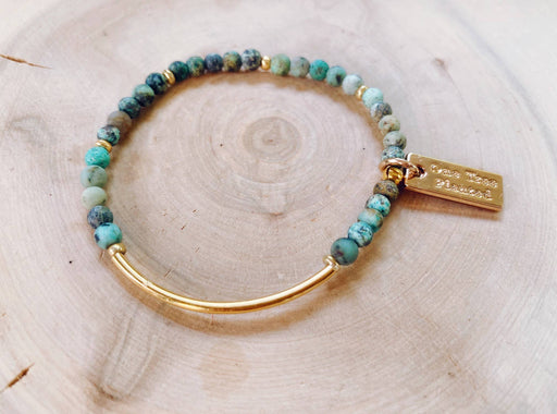 an african turquoise bracelet with a gold bar