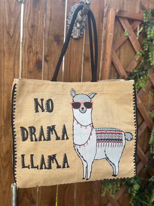 a tote bag black handles with a picture of a llama wearing sunglasses and festive attire and the words No Drama Llama on it