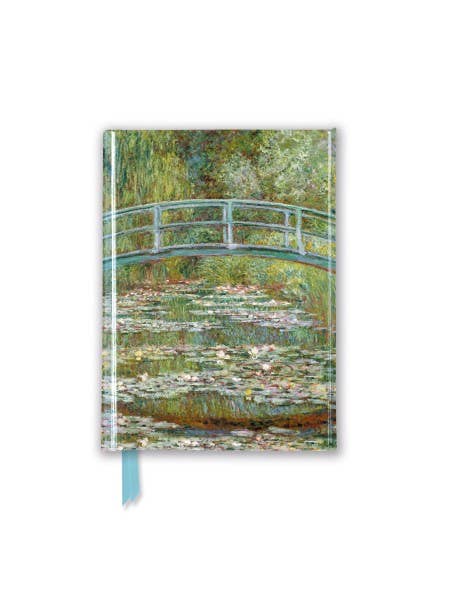 a notebook with a painting of a bridge over a pond of water lilies