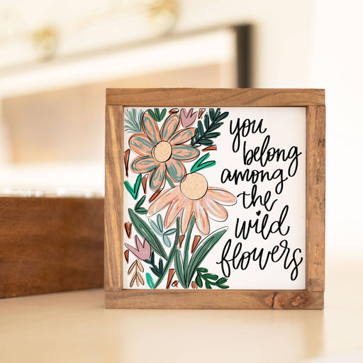 a picture frame with a picture of flowers on it and saying "you belong among the wild flowers"