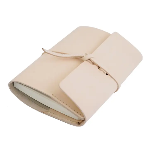 a white leather book with a tie on it
