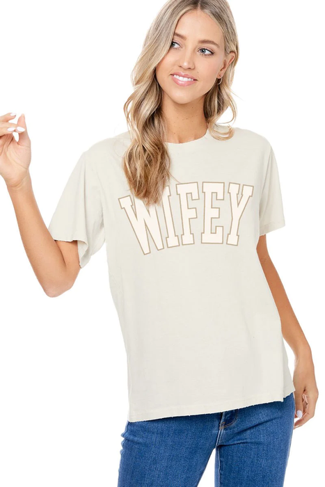 a woman wearing a white t - shirt with the word wifey on it